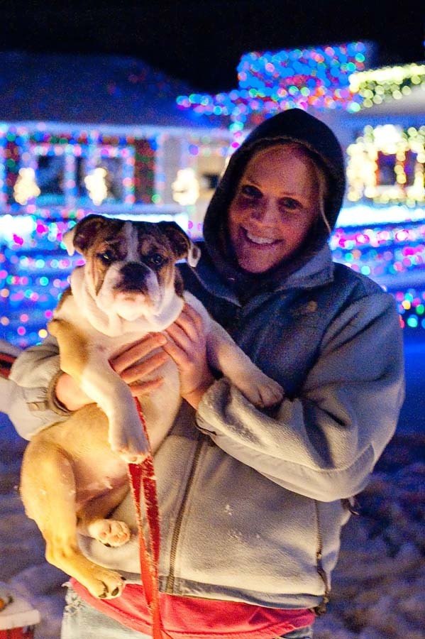 lady holding a dog in the snow